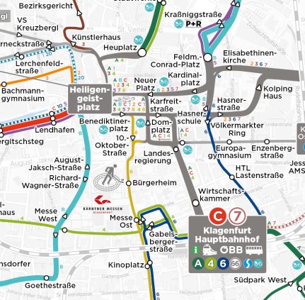 Ausschnitt des kartografischen KMG-Liniennetzes zeigt die Knotenpunkte Klagenfurt Hauptbahnhof und Heiligengeistplatz. Man sieht hier die verschiedenfärbigen Linien mit den jeweiligen Haltestellen, die von diesen Knotenpunkten aus in alle Himmeslrichtungen fahren.